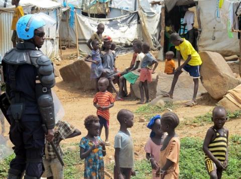 A UN peacekeeper keeps watch as children gather in a camp for displaced civilians in Juba, South Sudan, June 17, 2017. PHOTO BY REUTERS/David Lewis