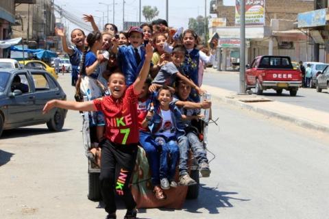 Iraqi children enjoy riding a mini car as they celebrate Eid al-Fitr, in Mosul, Iraq, June 25, 2017. PHOTO BY REUTERS/Alaa Al-Marjani