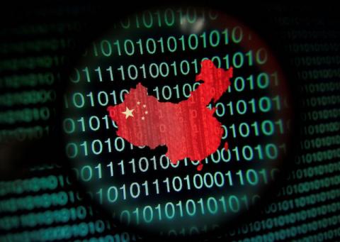 A map of China is seen through a magnifying glass on a computer screen showing binary digits in Singapore in this January 2, 2014 photo illustration. PHOTO BY REUTERS/Edgar Su