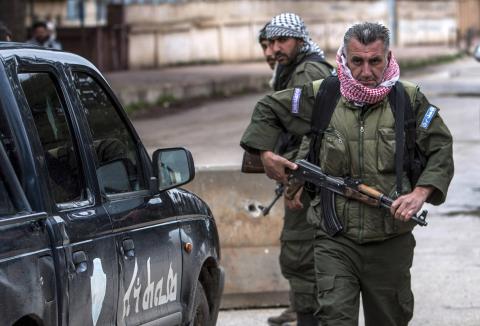Christian fighters of Sutoro (The Syriac Security Office) carry their weapons as they man a checkpoint in the town of Tel Tamr, February 25, 2015. PHOTO BY REUTERS/Rodi Said