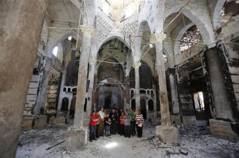 Bishop-General Macarius (6th L), a Coptic Orthodox leader, prays with residents at burnt and damaged Evangelical Church in Minya governorate, about 245 km (152 miles) south of Cairo