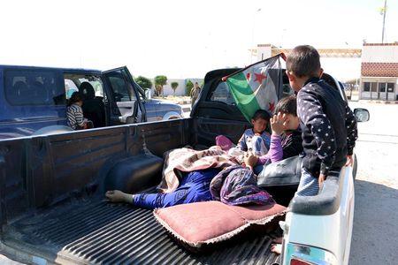 Civilians, who were wounded by what activists said was violence caused by Islamic State fighters in Kobani, wait with their relatives to cross into Turkey at the Syrian-Turkish border crossing of Tel Abyad, Syria, June 25, 2015. PHOTO BY REUTERS/Rodi Said