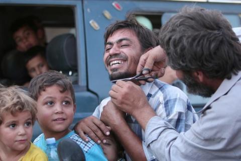 A man cuts the beard of a civilian who was evacuated with others by the Syria Democratic Forces fighters from an Islamic State-controlled neighbourhood of Manbij, in Aleppo Governorate. The SDF has said Islamic State was using civilians as human shields. PHOTO BY REUTERS/Rodi Said