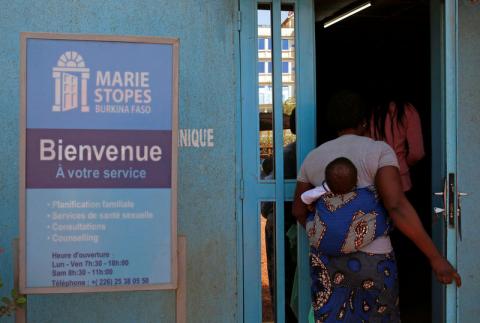 A woman carrying a baby arrives at the clinic of the NGO Marie Stopes in Ouagadougou, Burkina Faso, February 16, 2018. PHOTO BY REUTERS/Luc Gnago