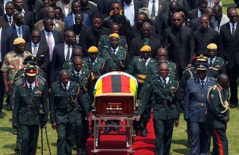 The body of Zimbabwe's founder and longtime ruler Robert Mugabe is brought to the national sports stadium for a state funeral in Harare, Zimbabwe. PHOTO BY REUTERS/Siphiwe Sibeko