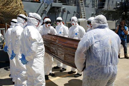 A coffin, containing the body of an unidentified migrant, is carried off the Irish Navy ship LE Niamh in the Sicilian harbour of Messina, Italy, July 29, 2015. PHOTO BY REUTERS/Antonio Parrinello