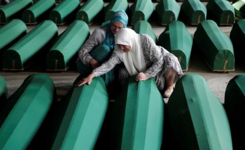 Muslim women cry near coffins of their relatives, who are newly identified victims of the 1995 Srebrenica massacre, which are lined up for a joint burial in Potocari near Srebrenica, Bosnia and Herzegovina, July 9, 2016. PHOTO BY REUTERS/Dado Ruvic