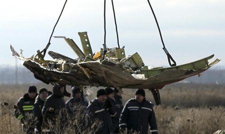 A crane transports a piece of the Malaysia Airlines flight MH17 wreckage at the site of the plane crash near the village of Hrabove (Grabovo) in Donetsk region, eastern Ukraine, November 20, 2014. PHOTO BY REUTERS/Antonio Bronic