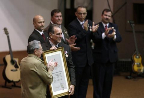 Cuba's President Raul Castro (front) stands next to Rene Gonzalez, one of the so-called "Cuban Five" during a ceremony in Havana, February 24, 2015. PHOTO BY REUTERS/Enrique De La Osa