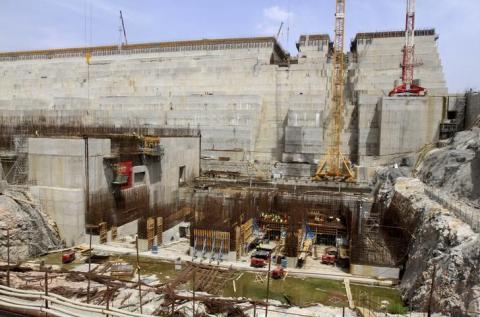 Construction workers are seen at a distance in a section of Ethiopia's Grand Renaissance Dam, as it undergoes construction, during a media tour along the river Nile in Benishangul Gumuz Region, Guba Woreda, in Ethiopia, March 31, 2015. PHOTO BY REUTER/Tiksa Negeri