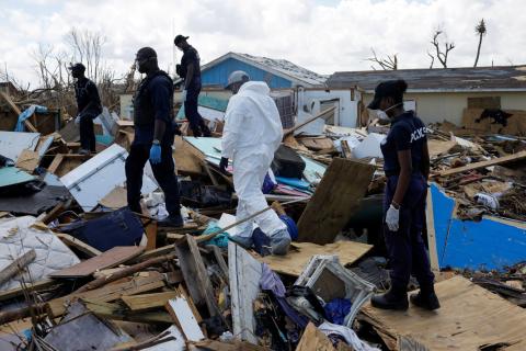 Police officers search for the dead in the destroyed Mudd neighborhood after Hurricane Dorian hit the Abaco Islands in Marsh Harbour, Bahamas, September 10, 2019. PHOTO BY REUTERS/Marco Bello