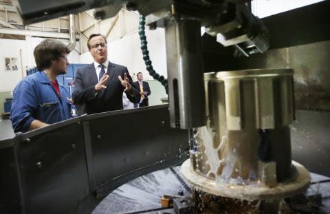 Britain's Prime Minister David Cameron speaks to a worker during a visit to engineering company MacTaggart Scott in Edinburgh, Scotland