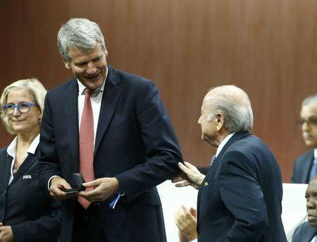 David Gill of England receives his nomination at the Executive Committee from FIFA President Sepp Blatter (R) at the 65th FIFA Congress in Zurich, Switzerland, May 29, 2015. REUTERS/Ruben Sprich