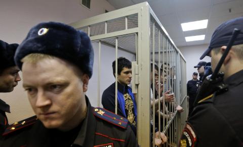 Defendants in the "Bolotnaya" case stand in a holding cell as they wait for their sentencing during a court hearing in Moscow
