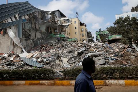 A man walks by as heavy machinery demolishes the UKAY Mall in Westlands, Nairobi, Kenya, August 14, 2018. PHOTO BY REUTERS/Baz Ratner