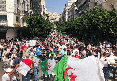 Demonstrators carry flags and banners during a protest demanding the removal of the ruling elite in Algiers, Algeria, September 10, 2019. PHOTO BY REUTERS/Abdelaziz Boumzar