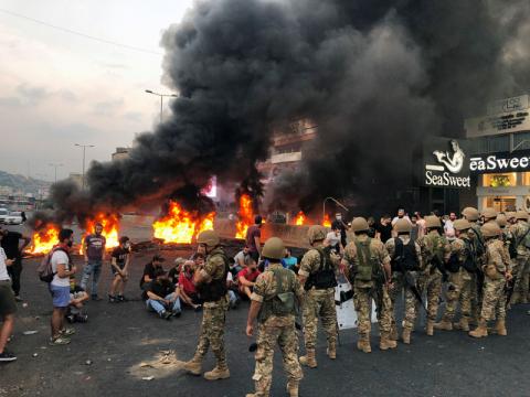 Demonstrators sit together during a protest over deteriorating economic situation, in the city of Jounieh, north of Beirut, Lebanon, October 18, 2019. PHOTO BY REUTERS/Imad Creidi