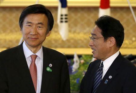 South Korea's Foreign Minister Yun Byung-se (L) talks with Japan's Foreign Minister Fumio Kishida before their meeting at the foreign ministry's Iikura guest house in Tokyo, June 21, 2015. PHOTO BY REUTERS/Issei Kato