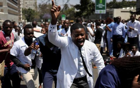 Doctors sing and hold placards during a protest over the disappearance of the leader of their union in Harare, Zimbabwe, September 16, 2019. PHOTO BY REUTERS/Siphiwe Sibeko