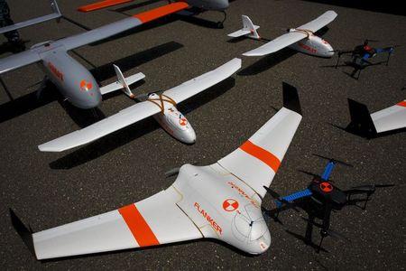 FireFlight UAS unmanned aerial vehicles TwinHawk, Scout, Flanker, and Hawkeye 400, are displayed on the tarmac during "Black Dart", a live-fly, live fire demonstration of 55 unmanned aerial vehicles, or drones, at Naval Base Ventura County Sea Range, Point Mugu, near Oxnard, California, July 31, 2015. PHOTO BY REUTERS/Patrick T. Fallon