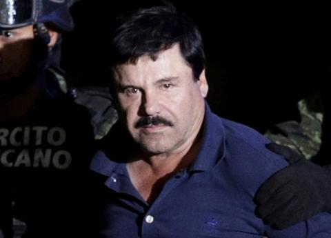 Recaptured drug lord Joaquin "El Chapo" Guzman is escorted by soldiers at the hangar belonging to the office of the Attorney General in Mexico City, Mexico, January 8, 2016. PHOTO BY REUTERS/Henry Romero