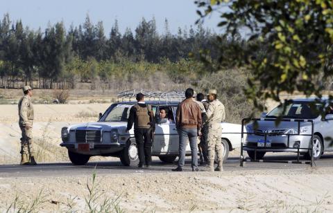 Egyptian security personnel check cars at a checkpoint near the site, where separate attacks on security forces in North Sinai on Thursday killed 30 people, in Arish, North Sinai, Egypt, January 31, 2015. PHOTO BY REUTERS/Stringer