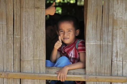 A primary school student at the Ei Thu Ta camp for displaced Karens along the Salween river in Myanmar gives a thumb-up, November 17, 2014. PHOTO BY REUTERS/Thin Lei Win