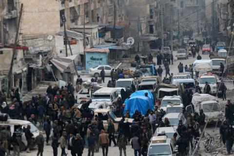 Rebel fighters and civilians wait to be evacuated from a rebel-held sector of eastern Aleppo, Syria December 18, 2016. PHOTO BY REUTERS/Abdalrhman Ismail