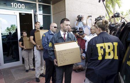 FBI agents bring out boxes after an operation inside the CONCACAF (Confederation of North, Central America and Caribbean Association Football) offices in Miami Beach, Florida, May 27, 2015. PHOTO BY REUTERS/Javier Galeano