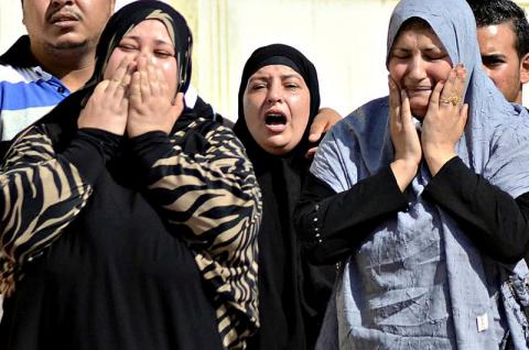 Family members of security forces killed in Sinai on Friday react as they wait for the bodies of their relatives at Almaza military airbase in Cairo, October 25, 2014. PHOTO BY REUTERS/Al Youm Al Saabi Newspaper
