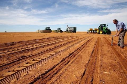A farmer inspects the soil ahead of planting at a maize field in Wesselsbron, a small maize farming town in the Free State province of South Africa, January 13, 2016. PHOTO BY REUTERS/Siphiwe Sibeko