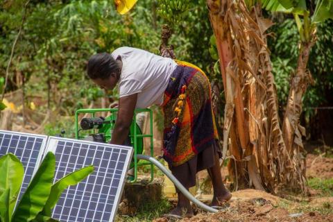 A Kenyan farmer sets up her solar irrigation pump in Busia county, Kenya on February, 2019. PHOTO BY REUTERS/Futurepump