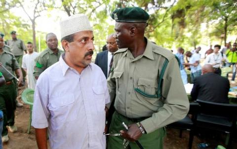Suspected Kenyan ring-leader of an ivory smuggling gang Feisal Ali Mohamed, also one of the nine most wanted environmental crime fugitives worldwide listed by Interpol, is escorted after the judgment on a case in which he had been charged with dealing and possession of 2,152 kg of ivory in Mombasa, Kenya, July 22, 2016. PHOTO BY REUTERS/Joseph Okanga