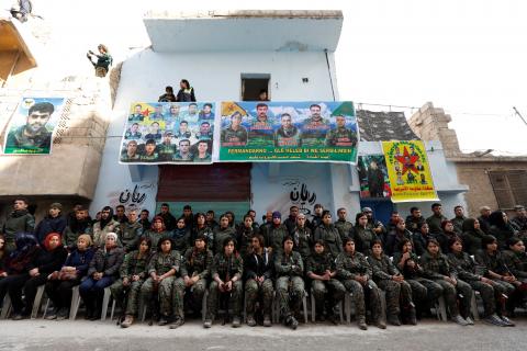 Kurdish female fighters of the Women's Protection Unit (YPJ) hold their weapons as they sit in the Sheikh Maksoud neighbourhood of Aleppo, Syria, February 7, 2018. PHOTO BY REUTERS/Omar Sanadiki