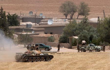 Kurdish People's Protection Units (YPG) fighters gather at the eastern entrances to the town of Tel Abyad of Raqqa governorate, June 14, 2015. PHTOT BY REUTERS/Rodi Said