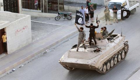 Islamic State fighters take part in a military parade along the streets of northern Raqqa province, June 30, 2014. PHOTO BY REUTERS/Stringer