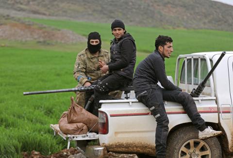 Turkish-backed Free Syrian Army fighters sit at a back of a pick-up truck near the city of Afrin, Syria, February 21, 2018. PHOTO BY REUTERS/Khalil Ashawi