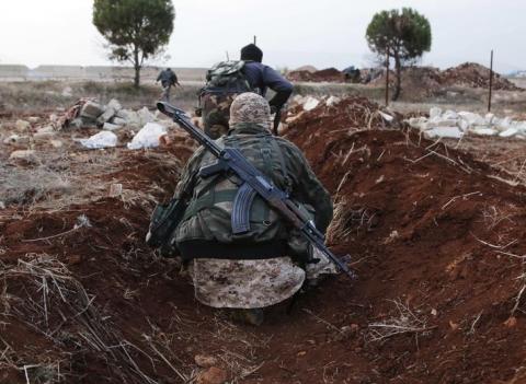 Members of al Qaeda's Nusra Front carry their weapons as they move towards their positions near al-Zahra village, north of Aleppo city, November 25, 2014. PHOTO BY REUTERS/Hosam Katan