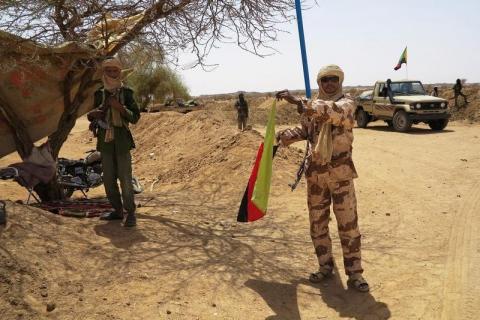 A fighter with the Tuareg separatist group MNLA (National Movement for the Liberation of Azawad) brandishes a separatist flag for the region they call Azawad outside the local regional assembly, where members of the rebel group met with the Malian army, the U.N. mission in Mali and French army officers, in Kidal