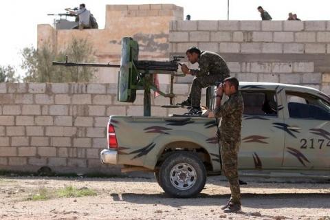 Syria Democratic Forces fighters look through a scope and a pair of binoculars on the outskirts of al-Shadadi town, in 47 village, Hasaka countryside, Syria February 19, 2016. PHOTO BY REUTERS/Rodi Said