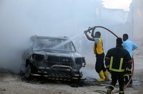 Fire fighters attempt to extinguish a burning car after an explosion in Mogadishu, Somalia, September 22, 2018. PHOTO BY REUTERS/Feisal Omar