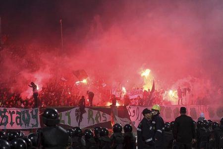 Police officers react as chaos erupts at a soccer stadium in Port Said city, Egypt, February 1, 2012. PHOTO BY REUTERS/Stringer