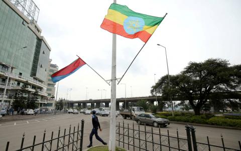 A police officer walks past the flags of Ethiopia and Eritrea ahead of Eritrea's President Isaias Afwerki's visit to Addis Ababa, Ethiopia, July 13, 2018. PHOTO BY REUTERS/Tiksa Negeri