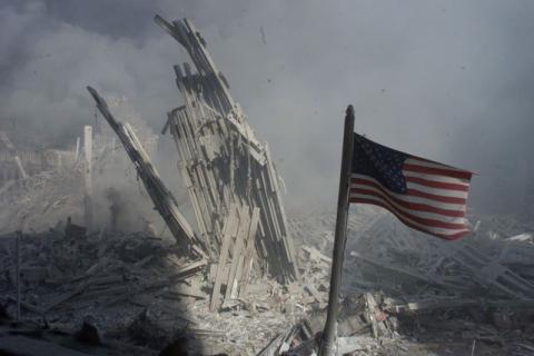An American flag flies near the base of the destroyed World Trade Center in New York, in this file photo from September 11, 2001, taken after the collapse of the towers. PHOTO BY REUTERS/Peter Morgan