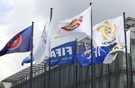 Flags are pictured in front of the headquarters of soccer's international governing body FIFA in Zurich, Switzerland, May 27, 2015. PHOTO BY REUTERS/Ruben Sprich