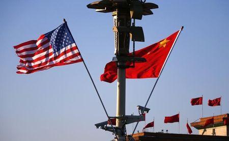 U.S. (L) and Chinese national flags flutter on a light post at the Tiananmen Square ahead of a welcoming ceremony for U.S. President Barack Obama, in Beijing, November 12, 2014. PHOTO BY REUTERS/Petar Kujundzic
