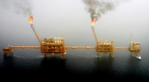 Gas flares from an oil production platform at the Soroush oil fields in the Persian Gulf, south of the capital Tehran, July 25, 2005. PHOTO BY REUTERS/Raheb Homavandi