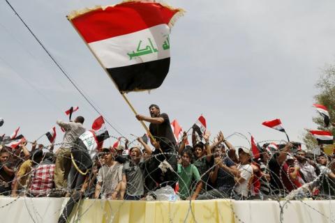 Followers of Iraq's Shi'ite cleric Moqtada al-Sadr chant slogans during a protest demanding that parliament approves a long-delayed new cabinet and end political and sectarian wrangling that is hampering a vote on the matter in the streets outside Baghdad's heavily fortified Green Zone in Iraq, April 26, 2016. PHOTO BY REUTERS/Ahmed Saad