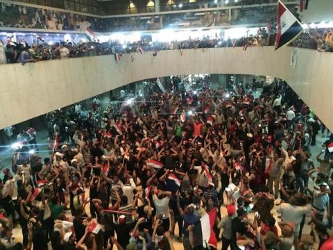 Followers of Iraq's Shi'ite cleric Moqtada al-Sadr are seen in the parliament building as they storm Baghdad's Green Zone after lawmakers failed to convene for a vote on overhauling the government, in Iraq, April 30, 2016. PHOTO BY REUTERS/Ahmed Saad