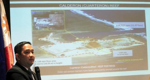 Francisco Acedillo, a lawmaker and a former air force pilot, shows a slide of China's reclamation work in the Spratly as he called for a creative strategy to deal with the maritime territorial dispute during a Foreign Correspondent of the Philippines (FOCAP) meeting in Manila March 26, 2015. PHOTO BY REUTERS/Romeo Ranoco